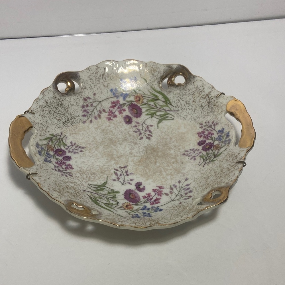vintage Japanese porcelain bowl with a floral design and decorative handles